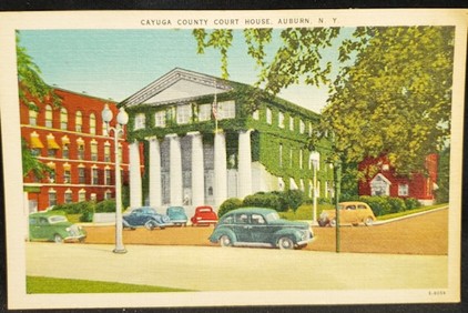 Mid-century postcard of the Cayuga County Courthouse covered in ivy, Auburn, New York